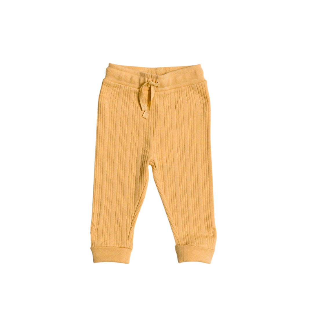 Yellow merino ribbed baby pants on a white background