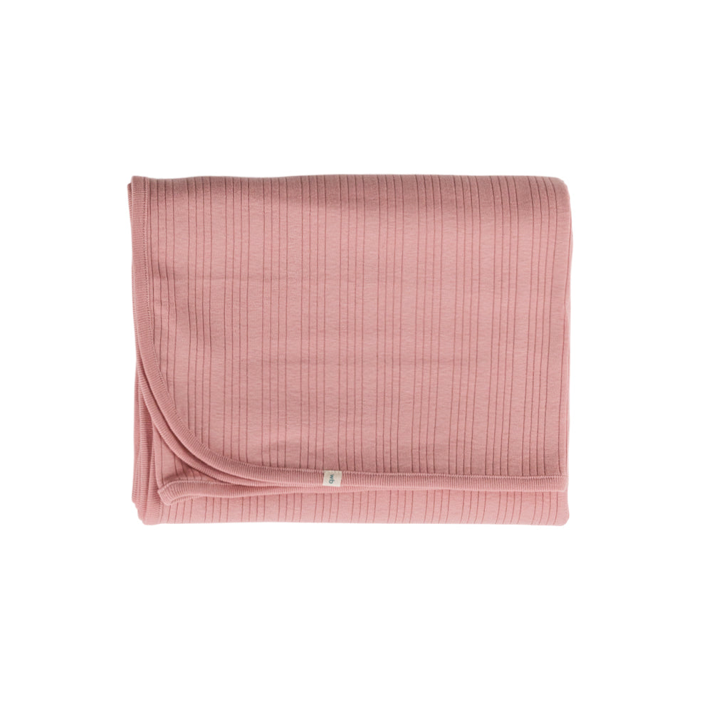 Pink textured woolbabe swaddle blanket on a white background