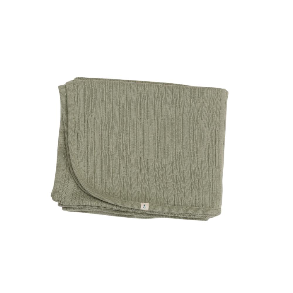 Folded flax green woolbabe blanket on a white background