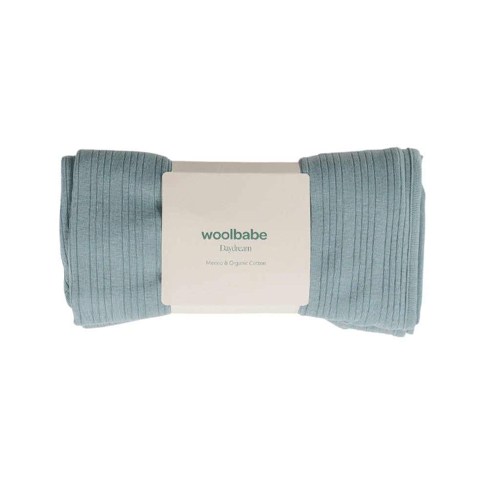 Wool blanket with 'woolbabe' packaging on a white background