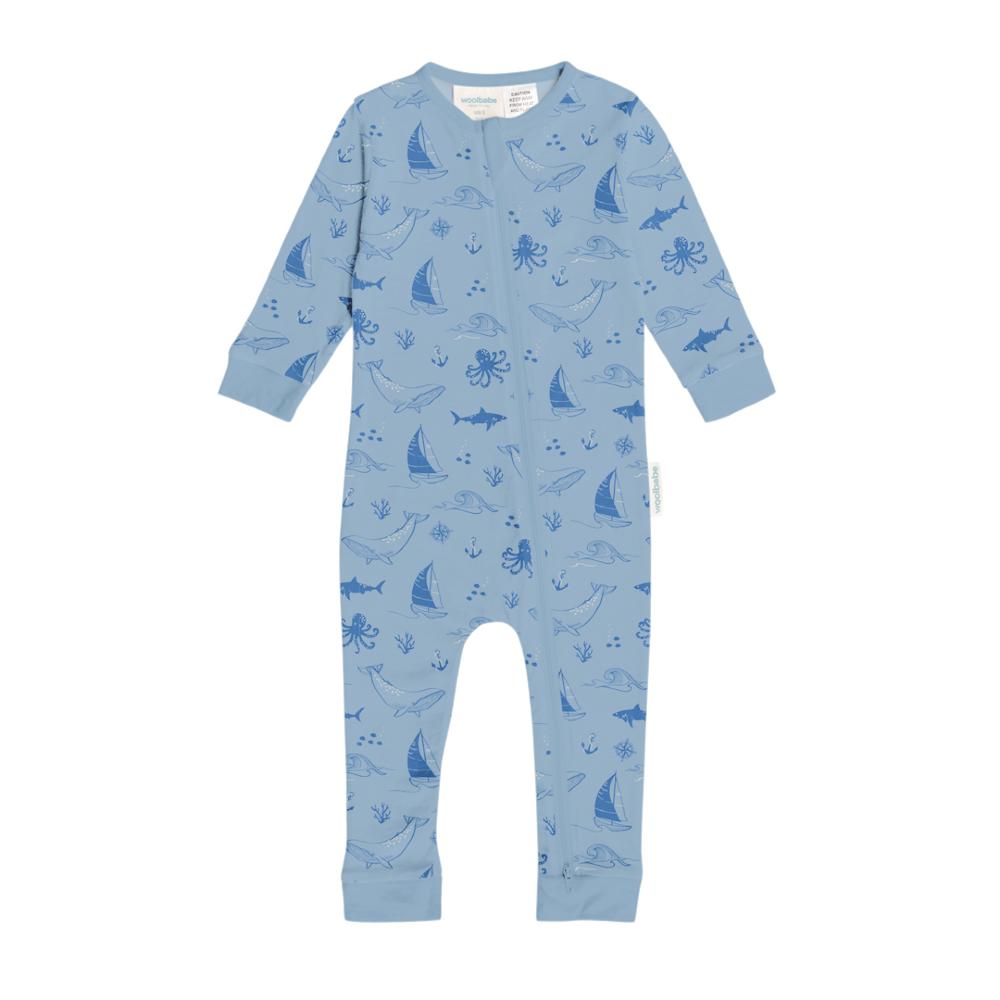 Blue woolbabe baby onesie with ocean-themed pattern on a white background