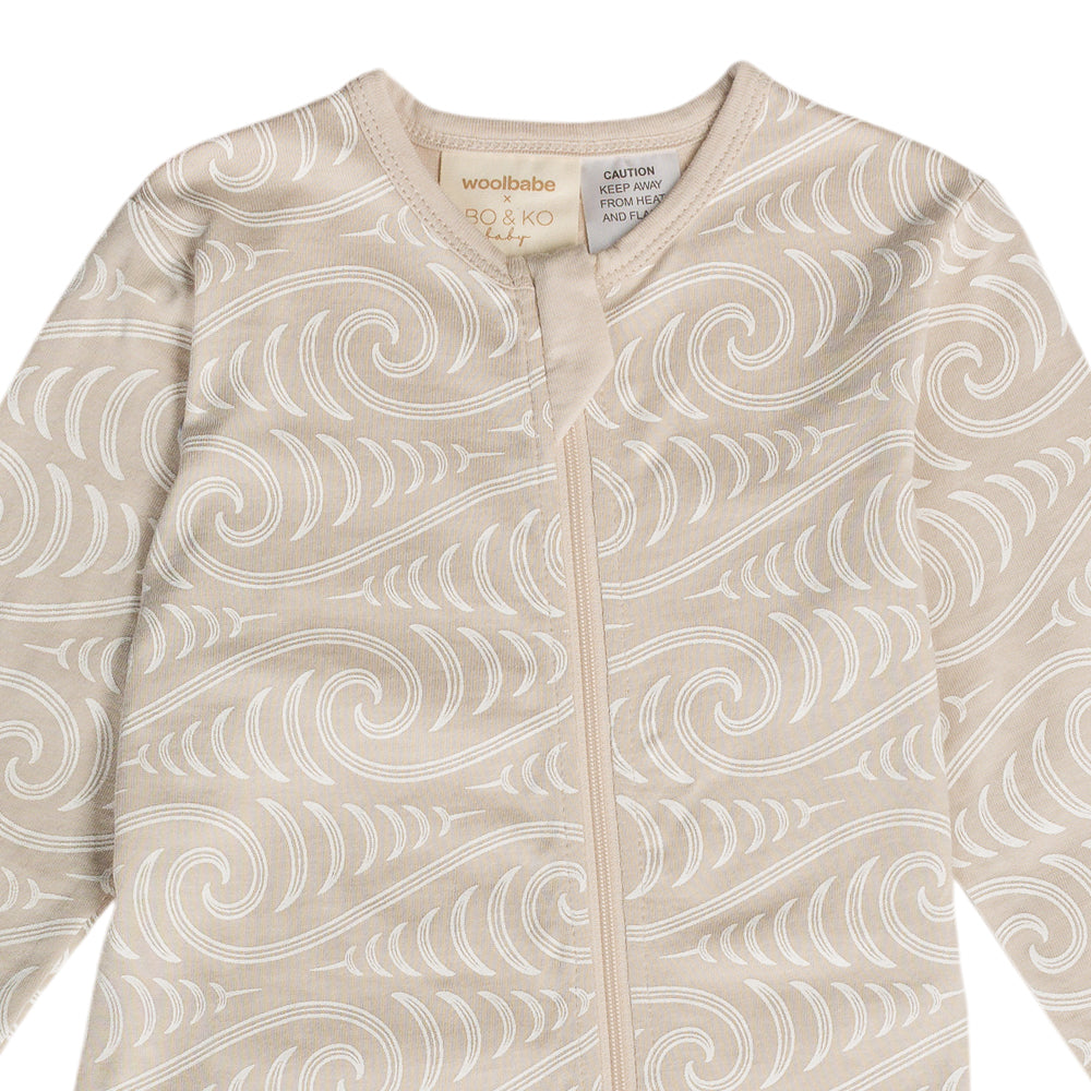 Maori design on baby onesie on white background
