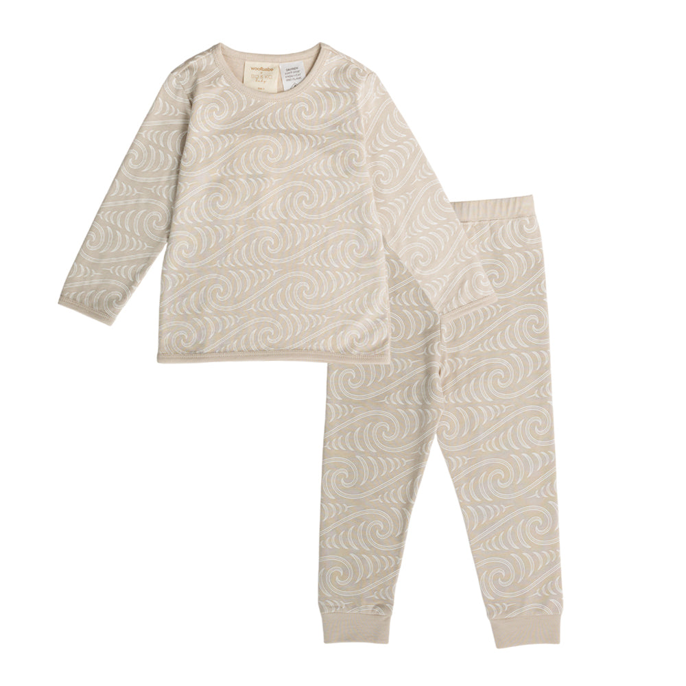 Beige pajama set with maori wave pattern on a white background
