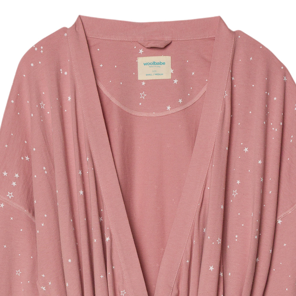 Pink cardigan with star pattern and Woolbabe label on a white background