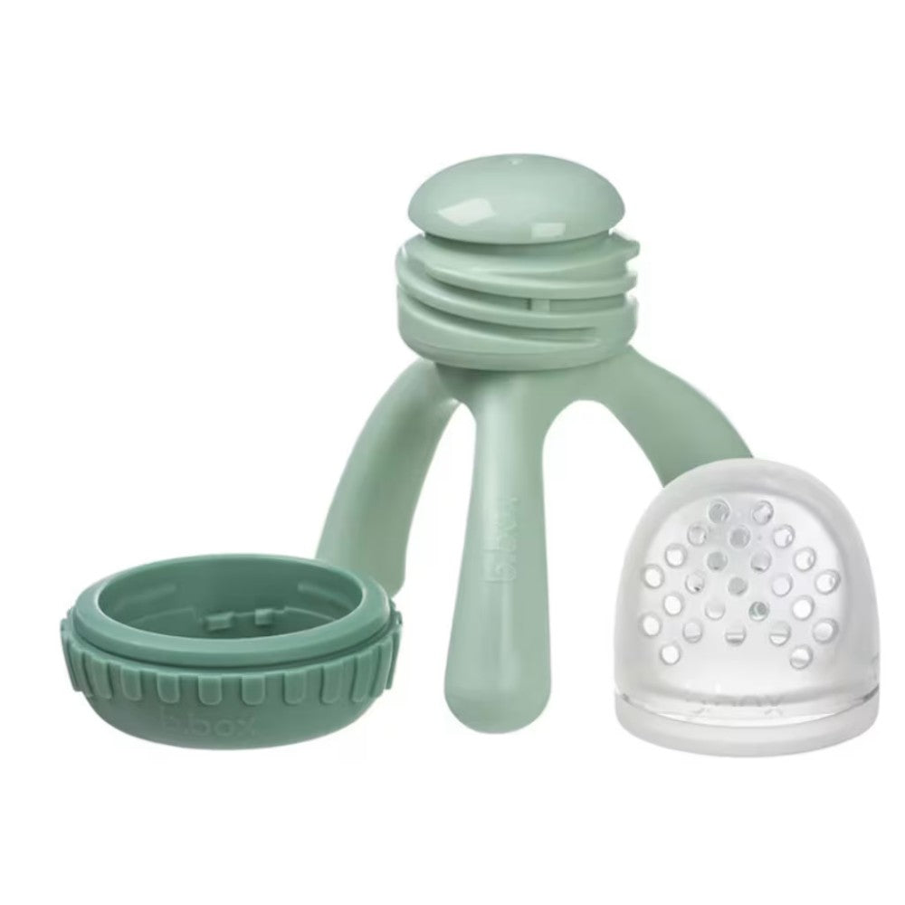 Green baby teething toy with a white mesh component on a white background