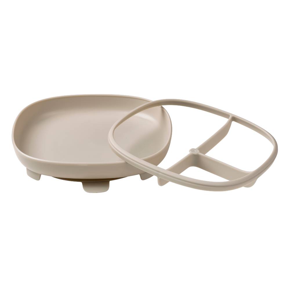 Beige plastic suction plate with separate divider on a white background
