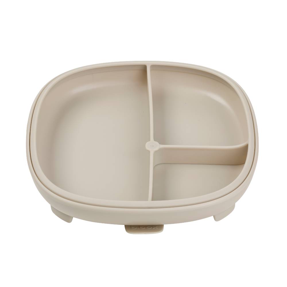 Beige plastic baby plate with a divided sections on a white background