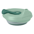 Light green silicone food pouch with spoon on a white background