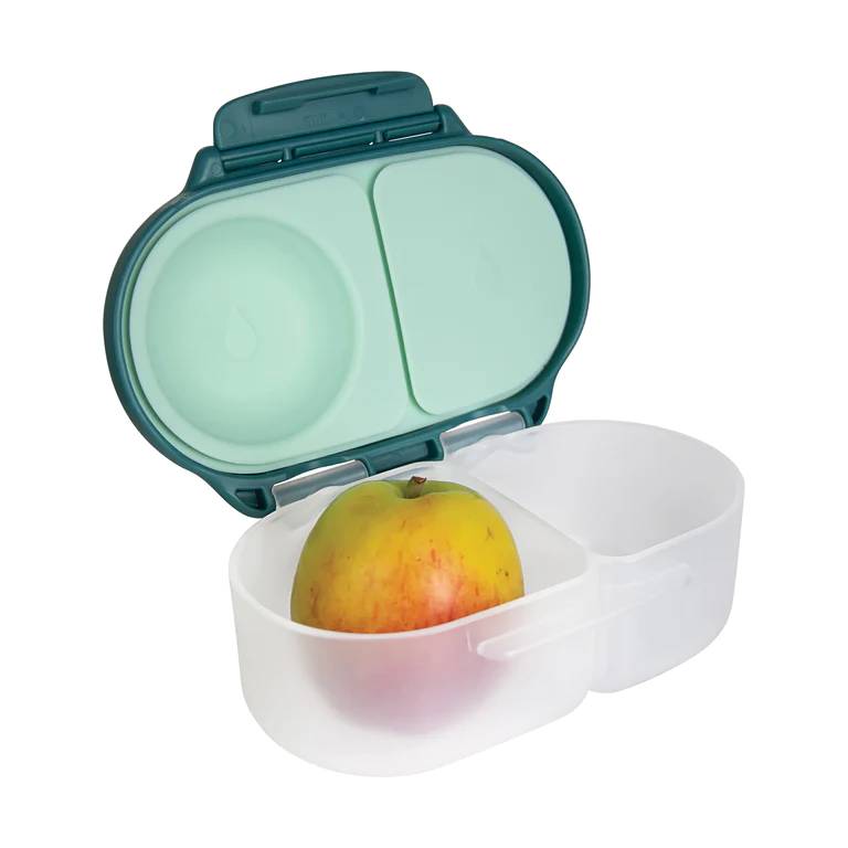 Portable snack box container with a green lid and white base holding an apple.