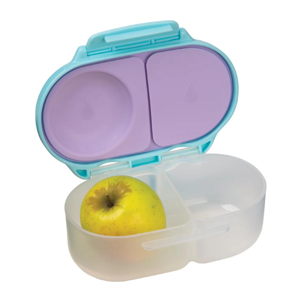 Open snack container with a yellow apple inside on a white background