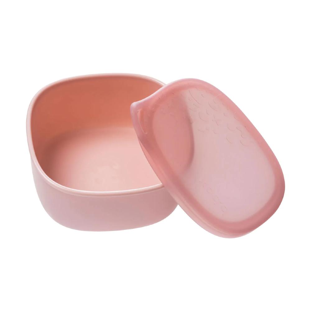 Pink plastic and silicone container with lid on a white background