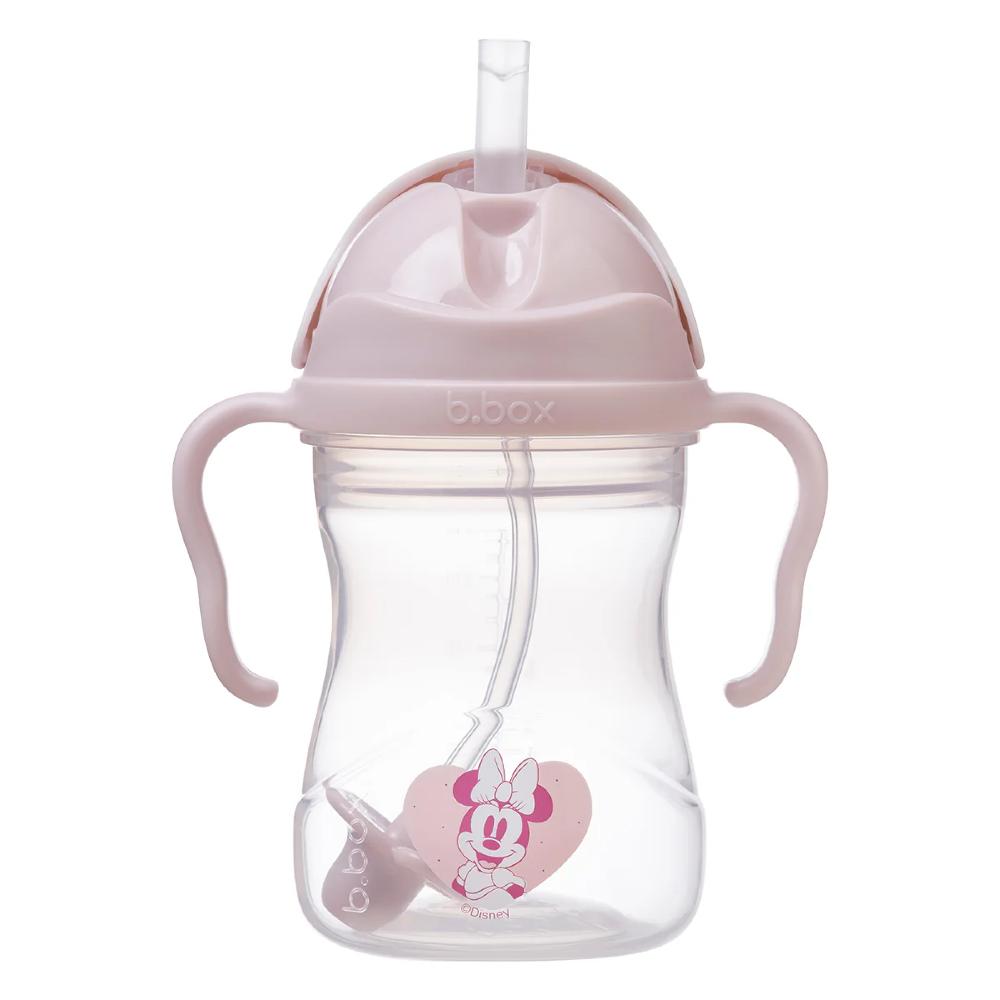 Pink sippy cup with straw and handles on a white background