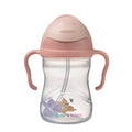 Pink and clear sippy cup with cartoon character Bambi on a white background