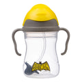 Batman-themed sippy cup with yellow lid and gray handles on a white background
