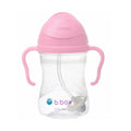 Clear sippy cup with pink lid and handles on a white background