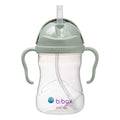 Clear sippy cup with green lid and handles on a white background, featuring the b.box logo.