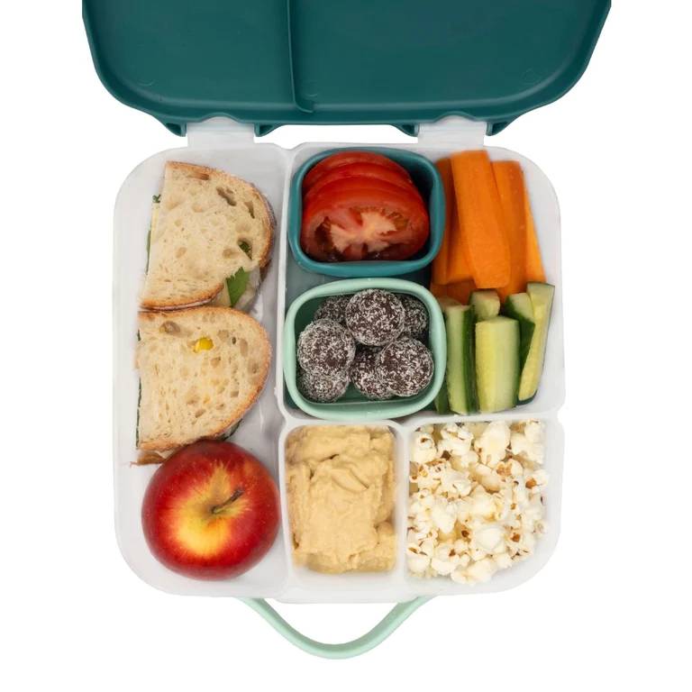 Lunchbox with compartments containing various food items on a white background