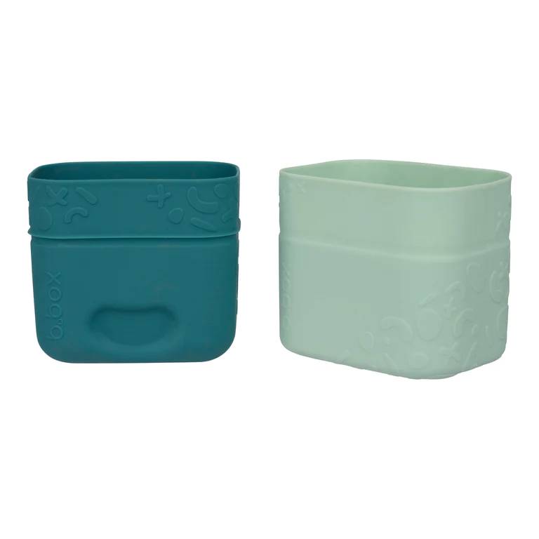 Two green silicone snack cups with textured design on a white background