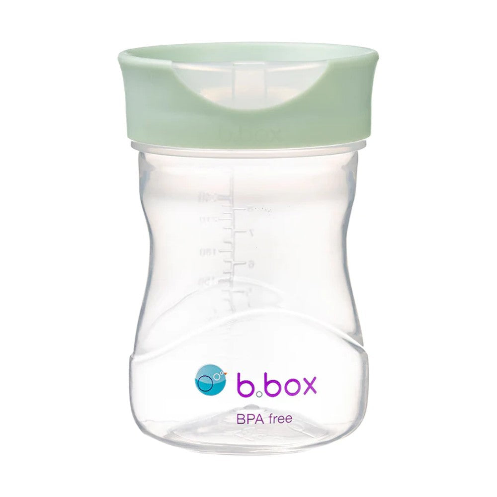 Clear b.box sippy cup with a green lid on a white background