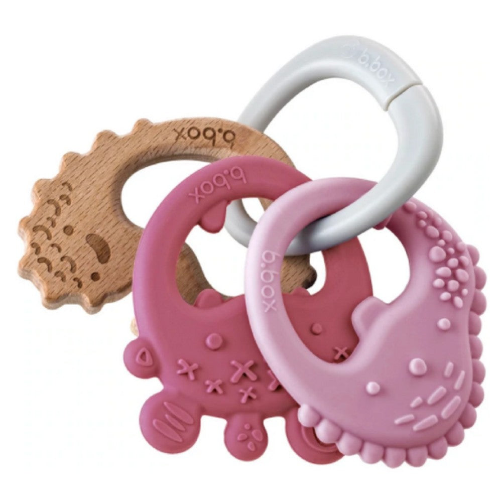 Set of baby teething rings with wooden and silicone designs on a white background