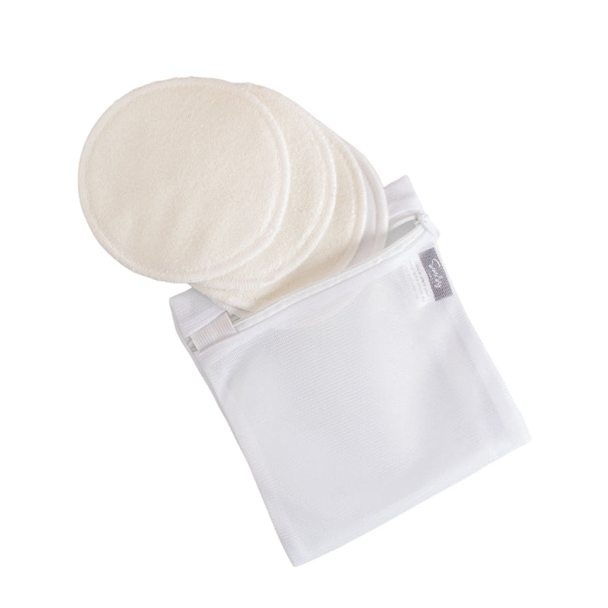 Set of white bamboo reusable breast pads in a clear mesh wash bag on a white background