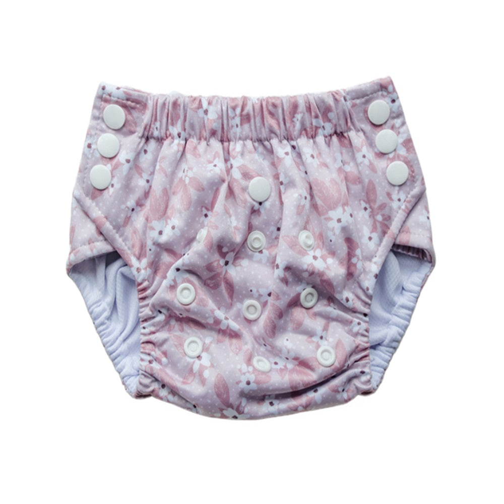 Reusable toddler pull-up style nappy with a floral pattern on a white background