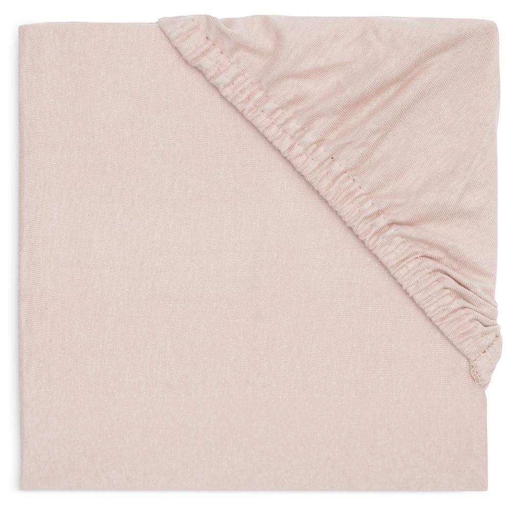 A folded light pink cotton sheet with a ribbed elasticated corner, shown on a clean white background.