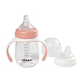Baby bottle with pink accents and a separate nipple on a white background