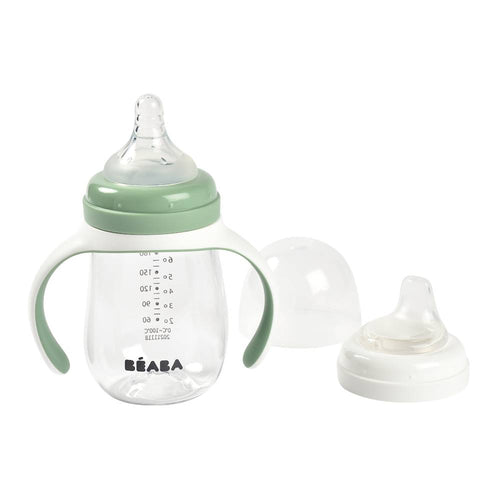 Béaba baby bottle with green handle and clear body on a white background