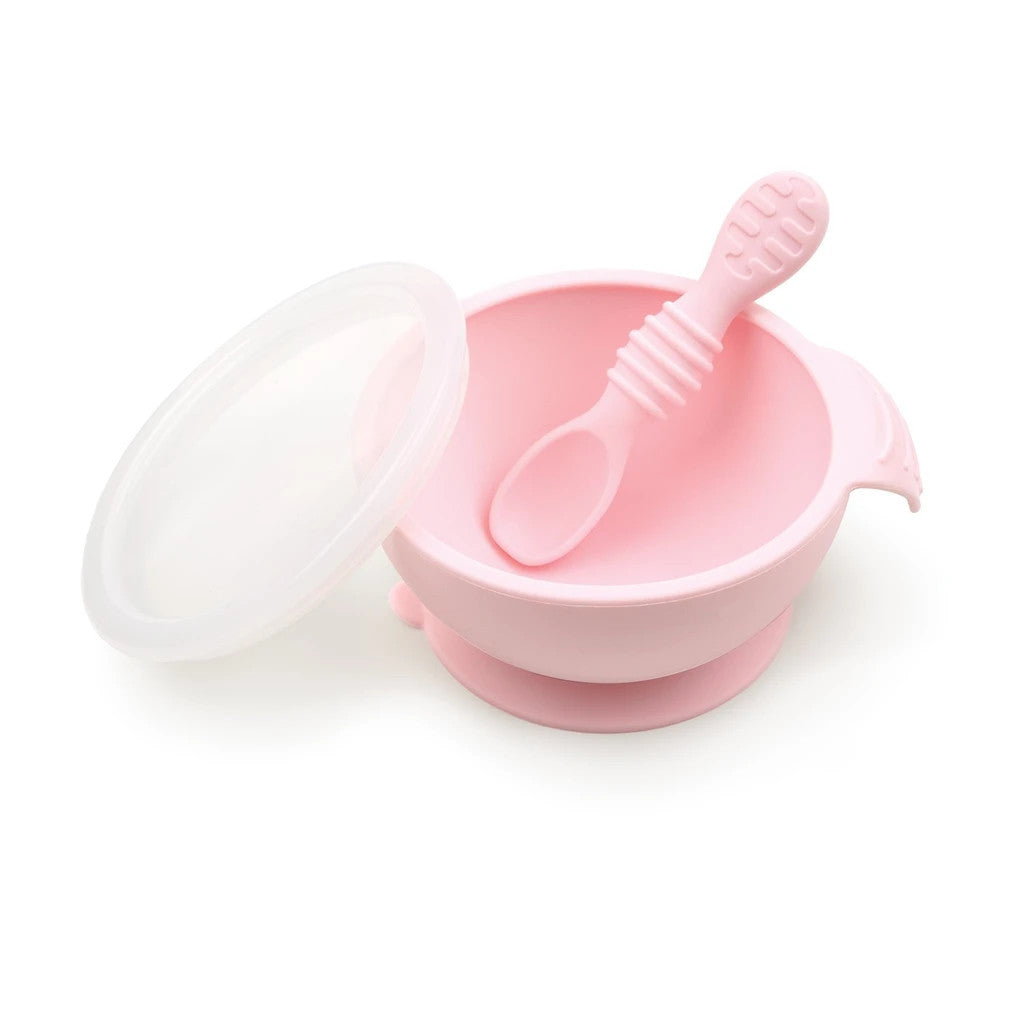 Pink Silicone Feeding Bowl with lid and silicone spoon on a white background
