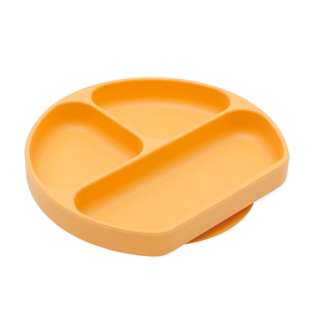 An orange bumkins silicone plate with three sections on a white background 