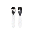 Stainless steel spoon and fork with white spotted silicone handles on a white background