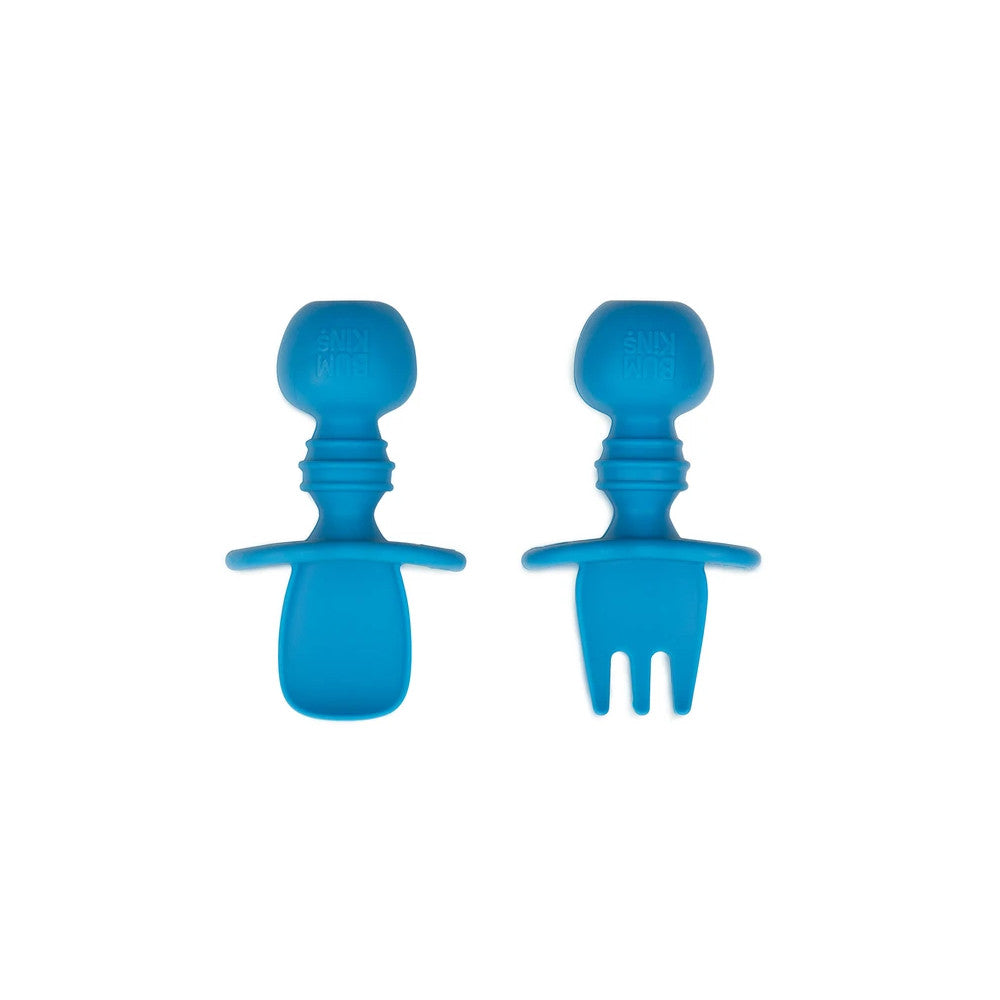 A dark blue set of silicone baby cutlery chewtensils including one spoon and one fork with bumkins logo on the handle