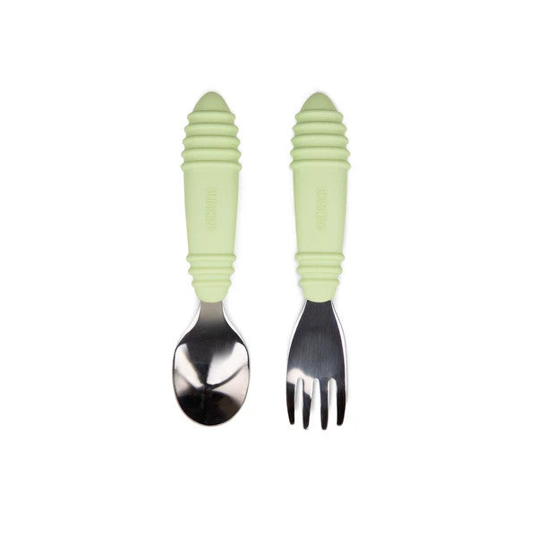 Stainless steel spoon and fork with sage green silicone handles on a white background