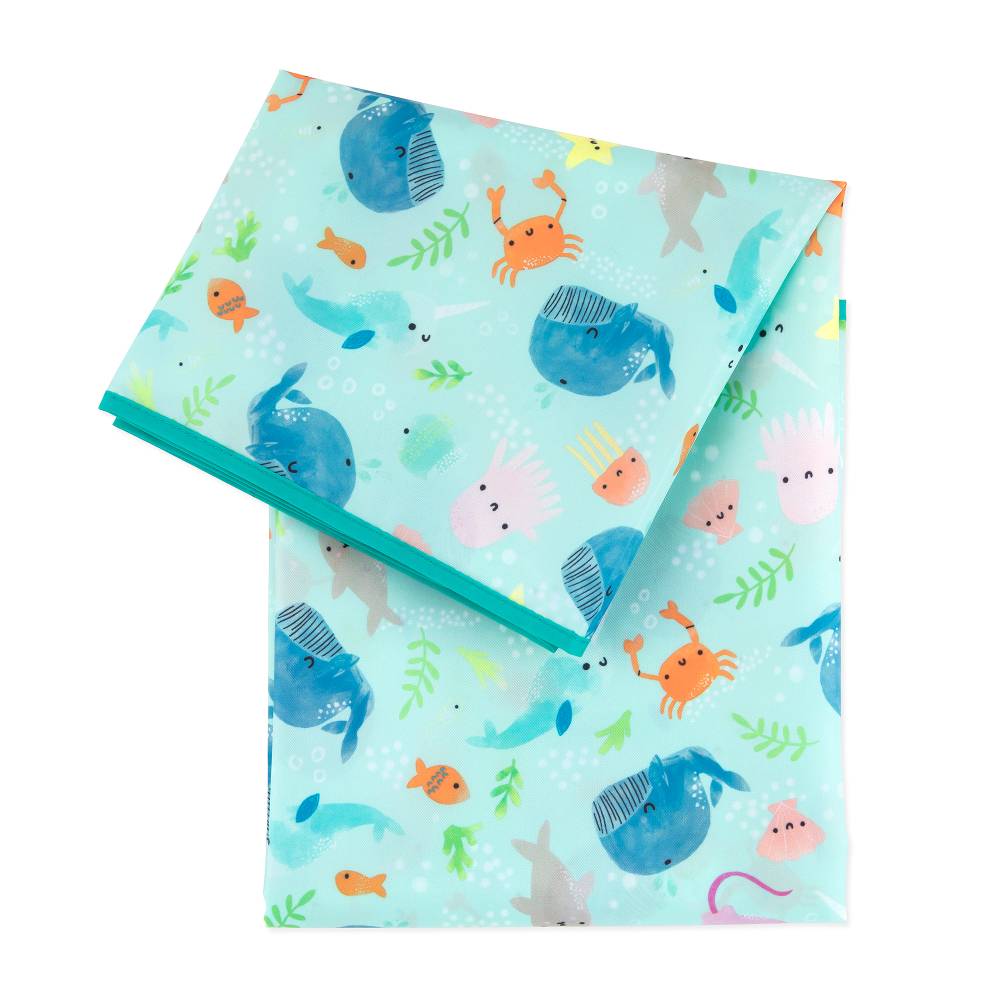 A splat mat with light blue background and ocean animal pattern on a white background