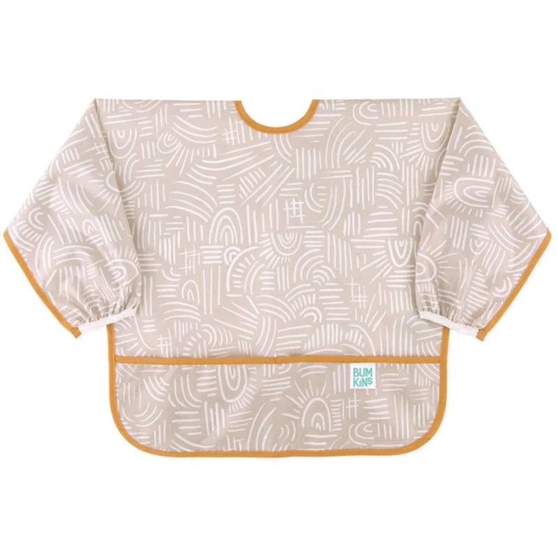 A long sleeve bib with elasticated wrists and front pocket in beige lines pattern and bumkins tag