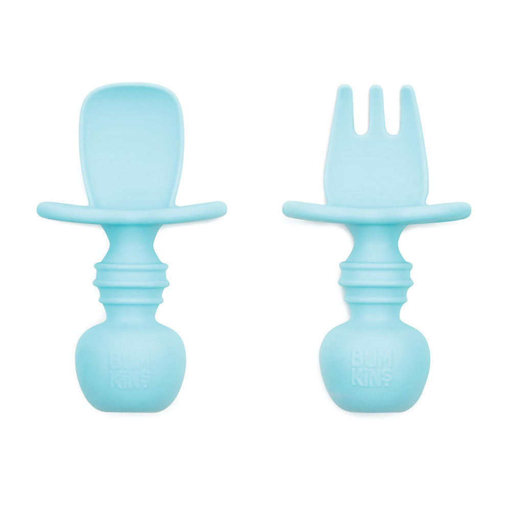 An aqua blue set of silicone baby cutlery chewtensils including one spoon and one fork with bumkins logo on the handle 