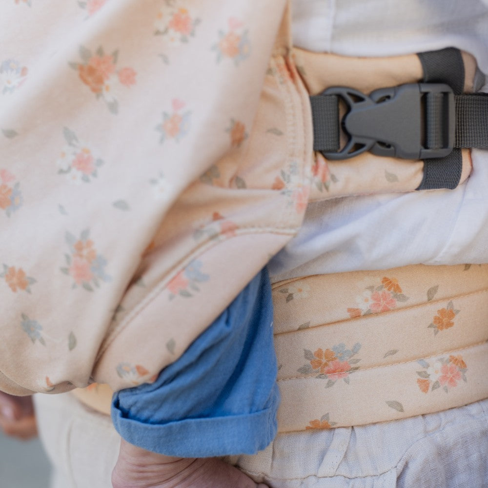 Close-up of a Bliss baby carrier with floral pattern