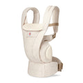 Beige baby carrier with a visible brand logo on a white background