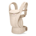 Beige baby carrier on a white baby carrier. 