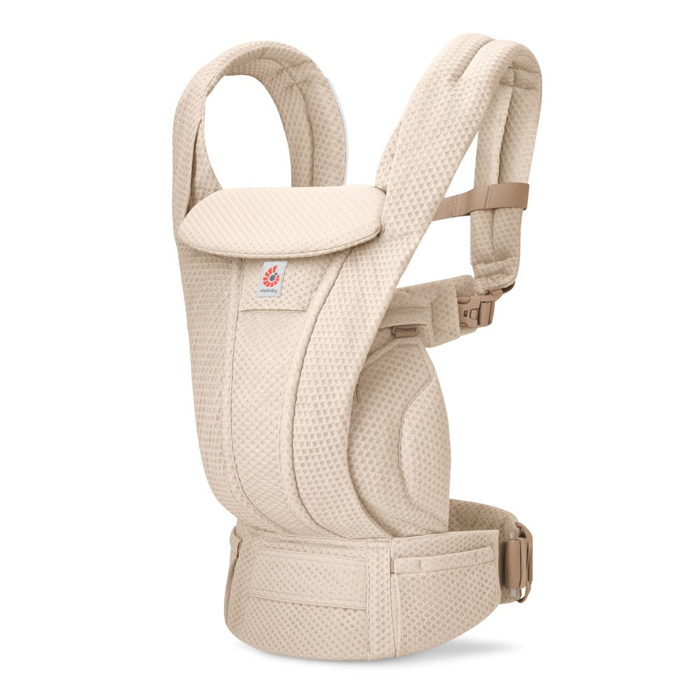 Beige baby carrier on a white baby carrier. 