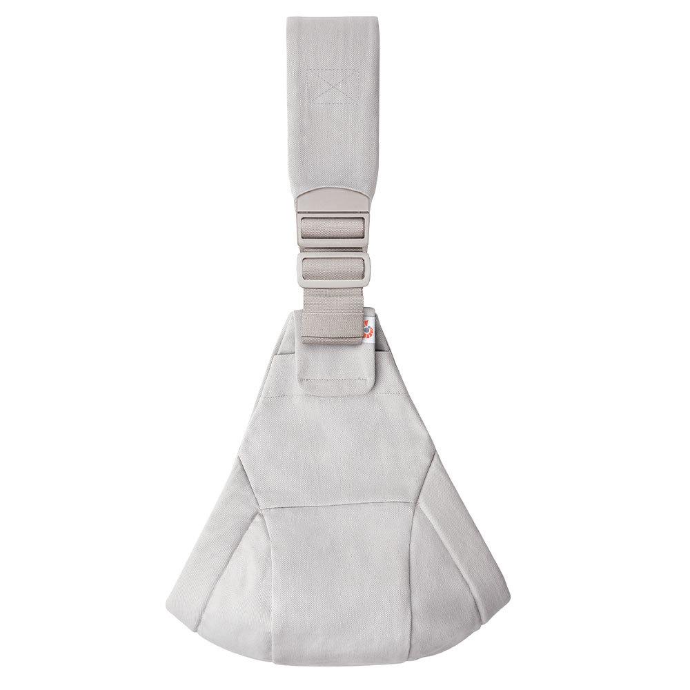 A light gray toddler hip carrier with an adjustable shoulder strap and buckle, shown against a plain white background.