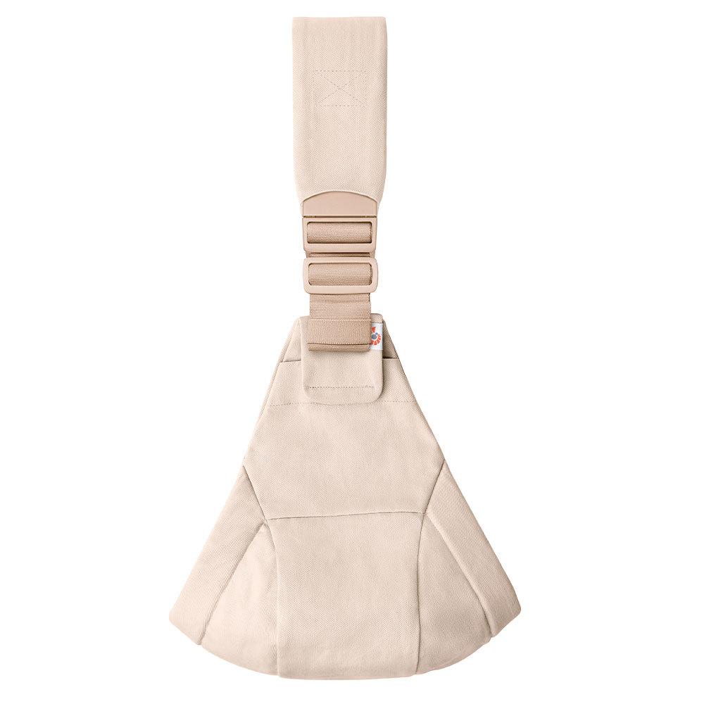 Beige toddler hip carrier with an adjustable shoulder strap and buckle, shown against a plain white background.
