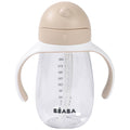 A clear plastic baby sippy cup with integrated white handles, a beige lid, and a beige side grip, featuring the BEABA brand name printed in black at the bottom.