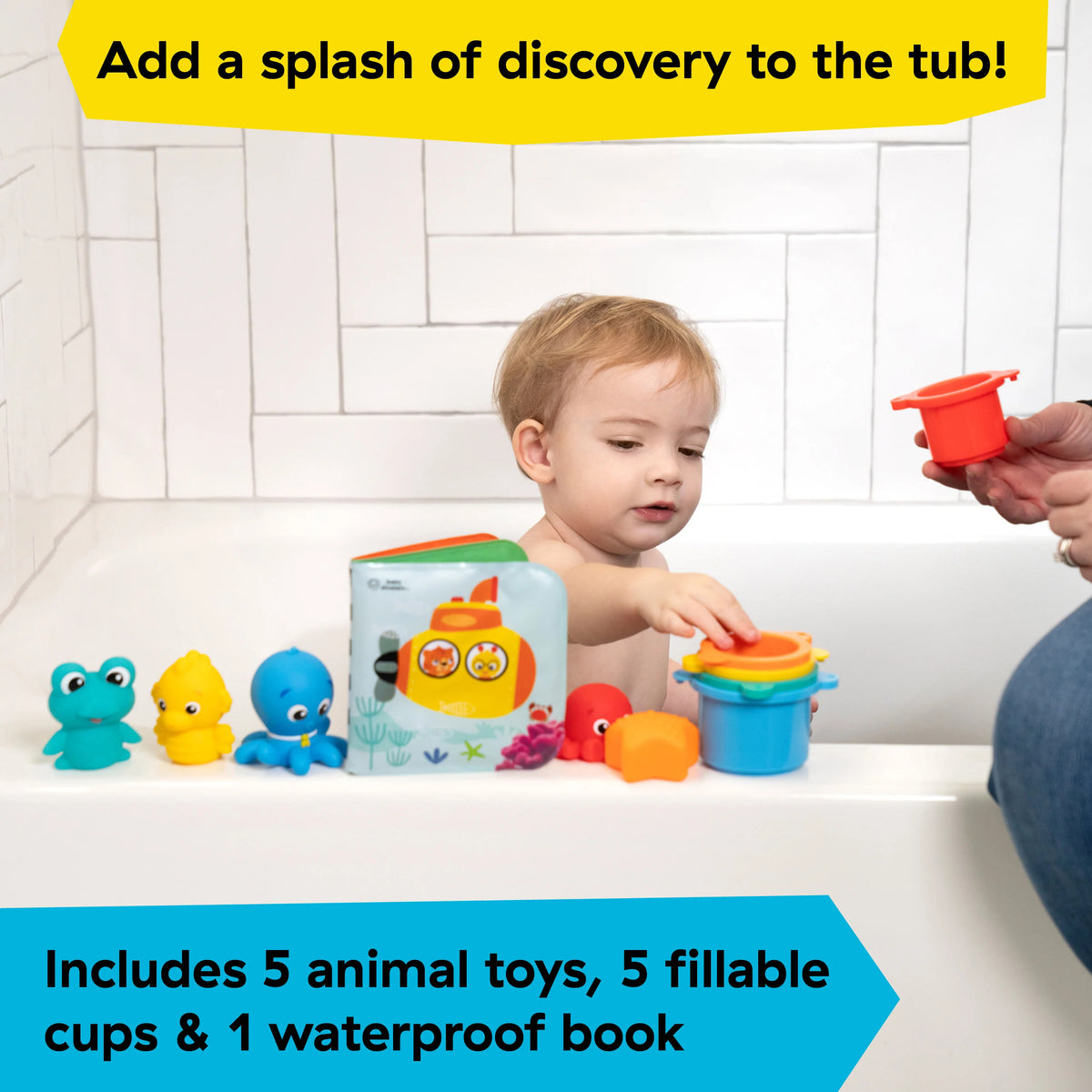 A young child in a bath playing with colourful bath toys.