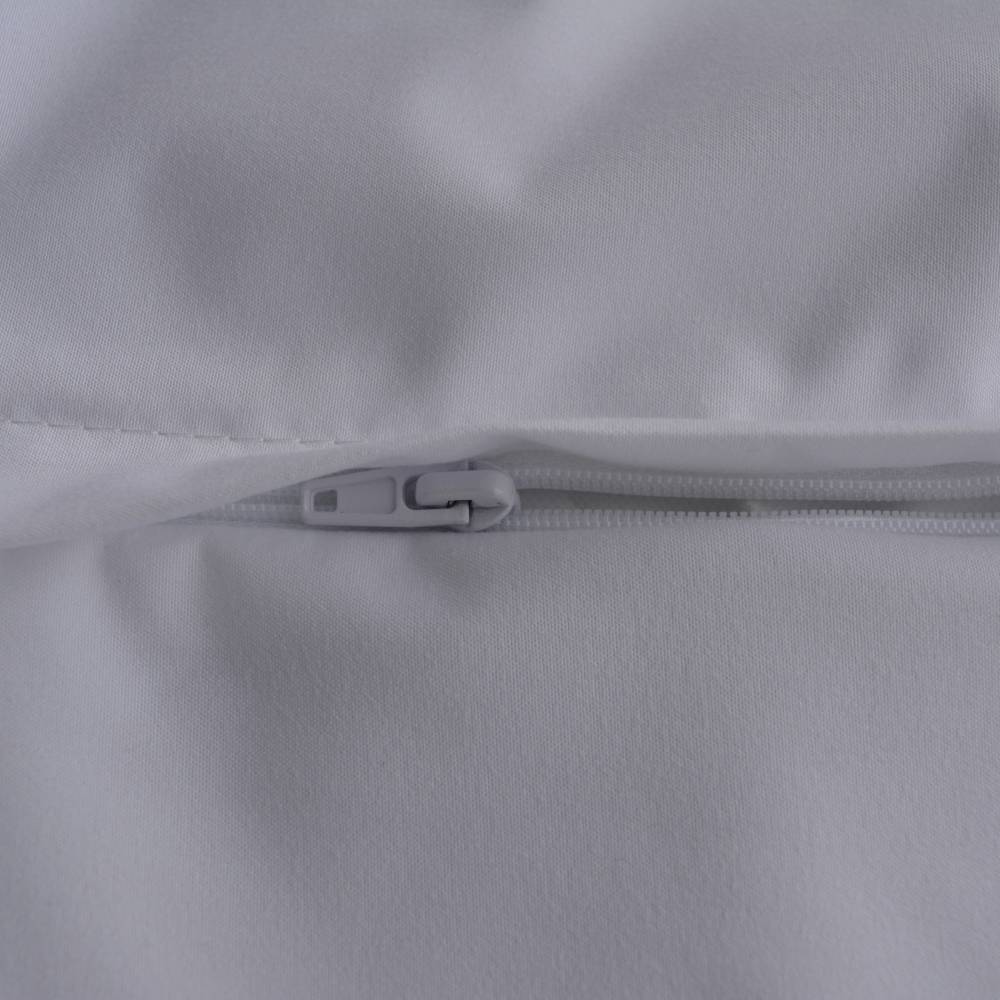 Close-up of a white zipper pull and zipper track on a white or very light gray fabric surface.