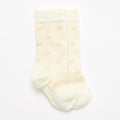 Cream knee high socks on a white background