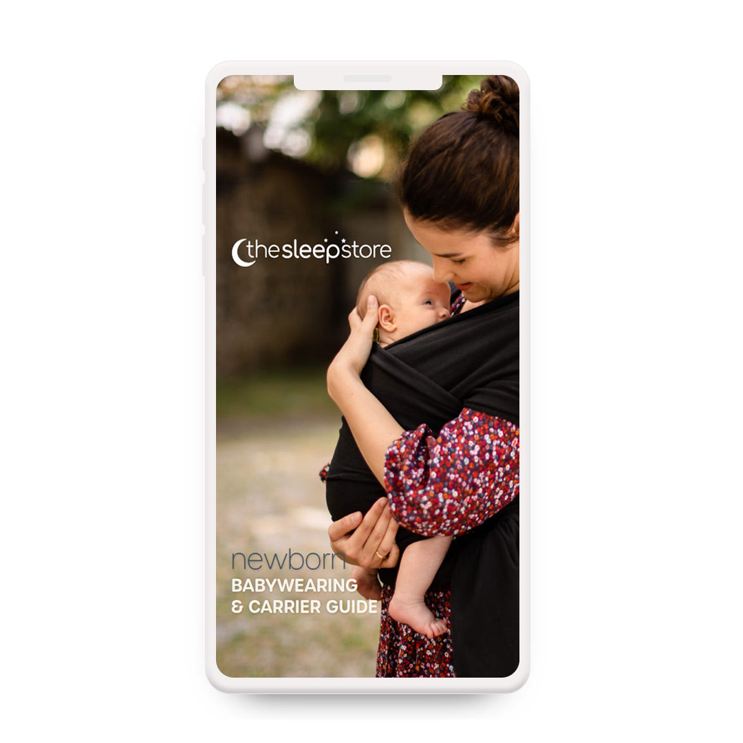 A smartphone-style mockup displaying a guide cover for 'the sleepstore newborn babywearing & carrier guide,' featuring a woman in a black baby carrier holding a baby outdoors.