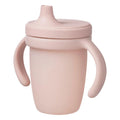Pink sippy cup with handles on a white background