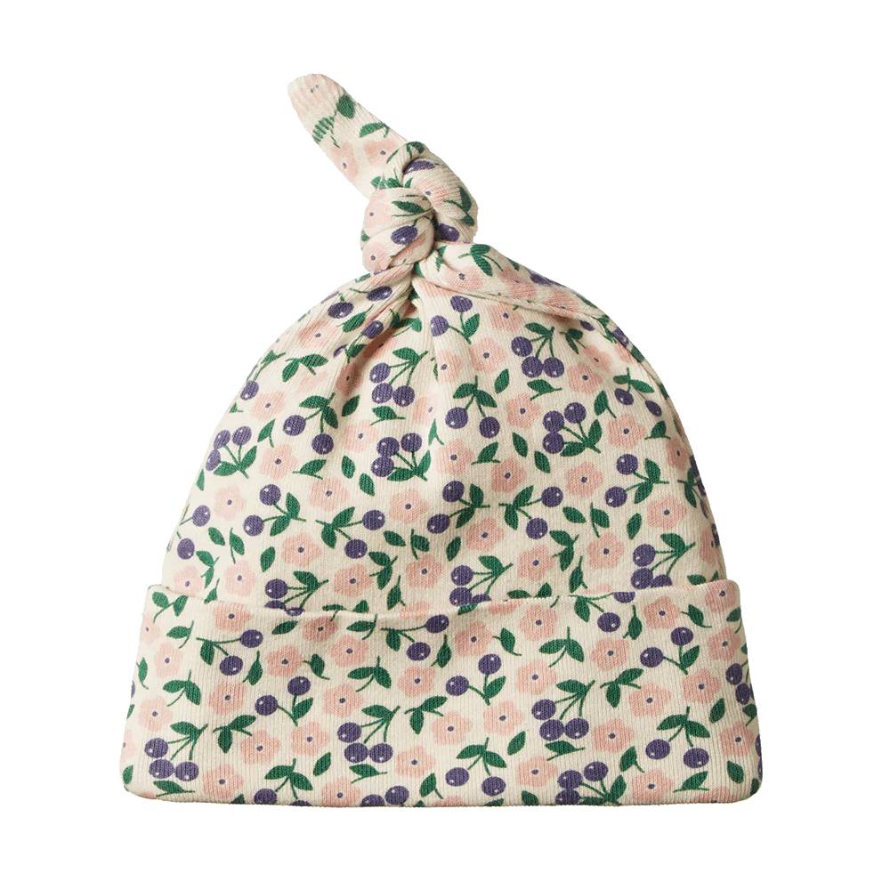 Cream, purple, green and pink Floral patterned baby hat with top knot on a white background